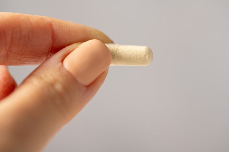 osoba drži suplement u ruci